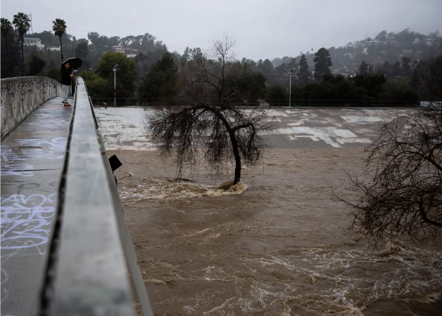 The swirling Los Angeles River on Monday.Credit...Jenna Schoenefeld for The New York Times